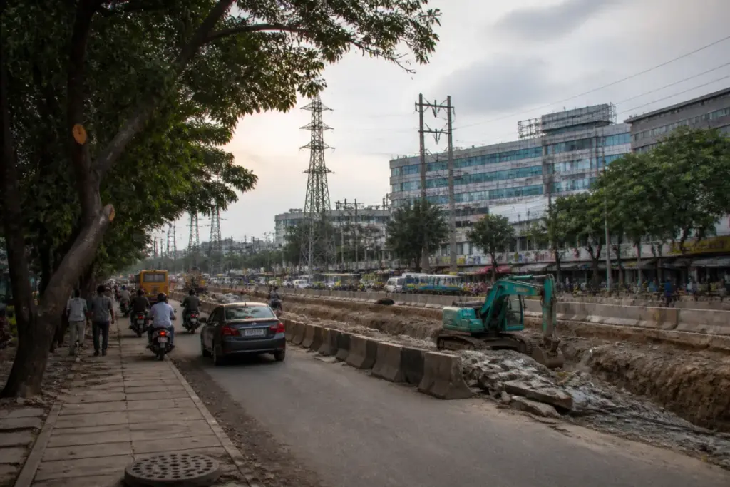 Allwyn-Miyapur flyover corridor with mature trees and ongoing road excavation in Hyderabad