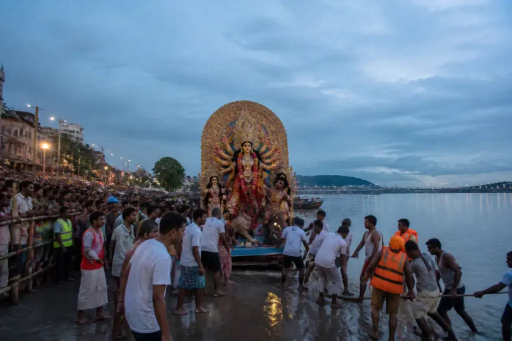 Guwahati Durga idol immersion procession arriving at a designated riverside ghat