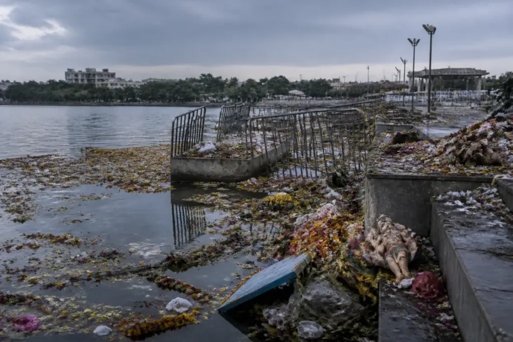 Futala Lake waste and discarded idols along Nagpur's lakefront after immersion.
