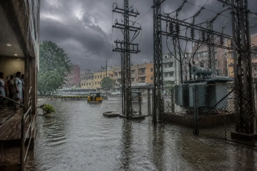 Tamil Nadu lightning safety advisory illustrated by a waterlogged street near electrical infrastructure