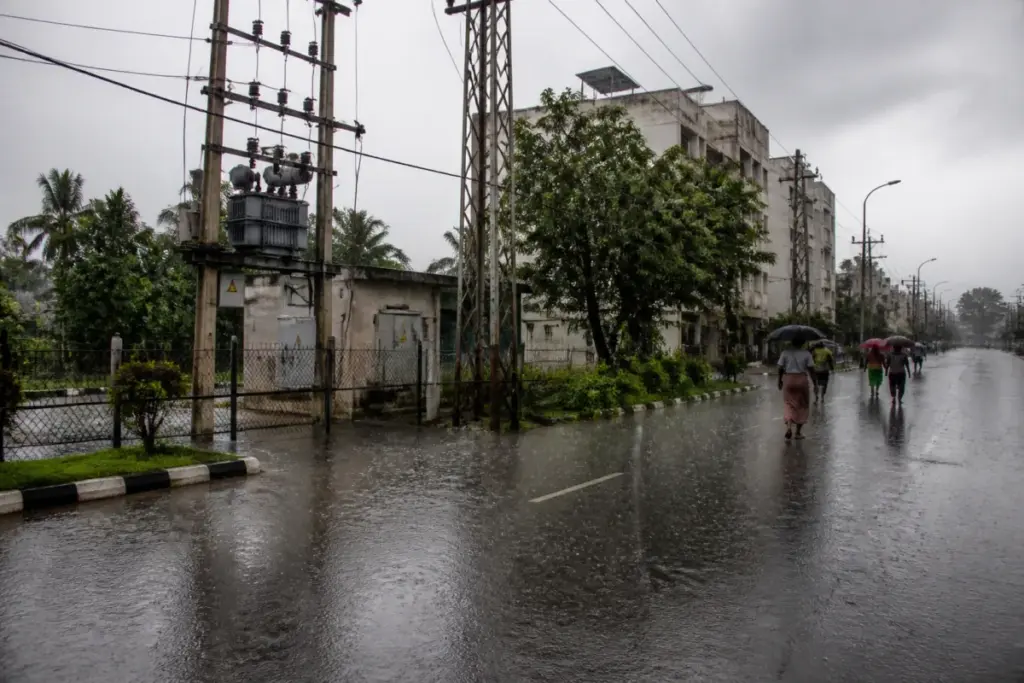Tamil Nadu power safety advisory near a waterlogged street and electrical infrastructure during monsoon rain