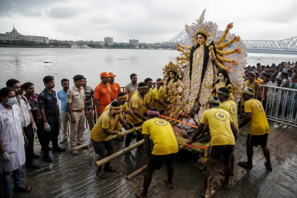 Durga idol immersion preparations at a Kolkata ghat along the Hooghly River