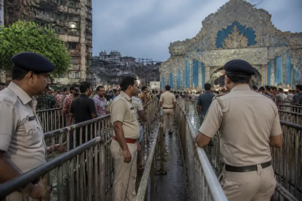 Kolkata pandal stampede inquiry at a crowded Durga Puja venue with barricades and emergency access routes