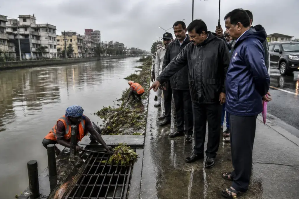 Chennai monsoon works being inspected near a storm water canal during rainfall