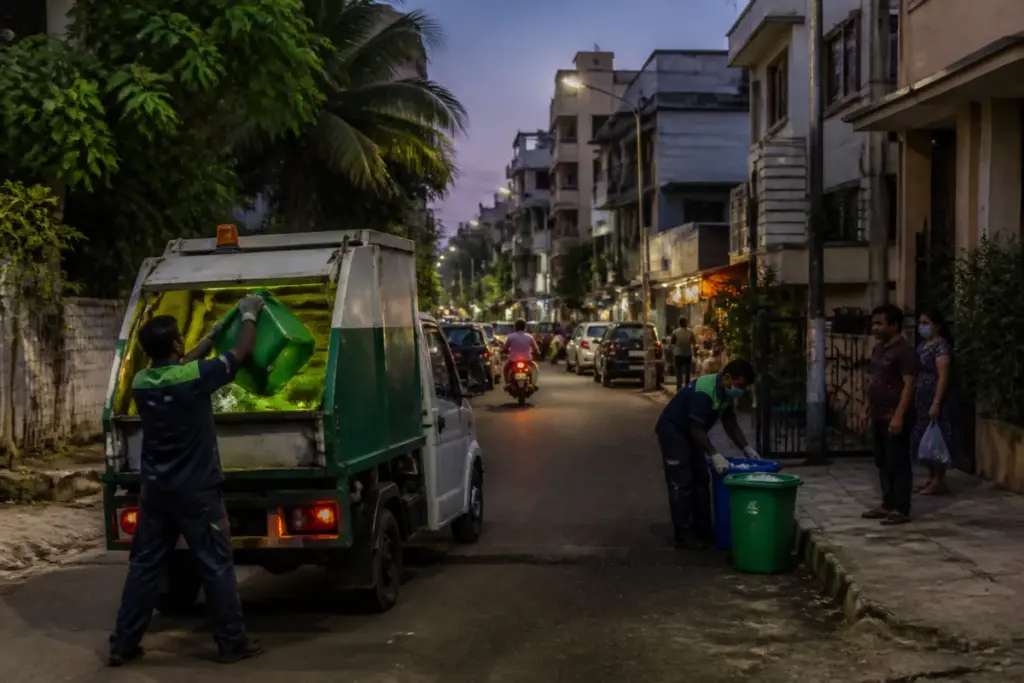 Bengaluru evening waste collection vehicle operating on a residential street