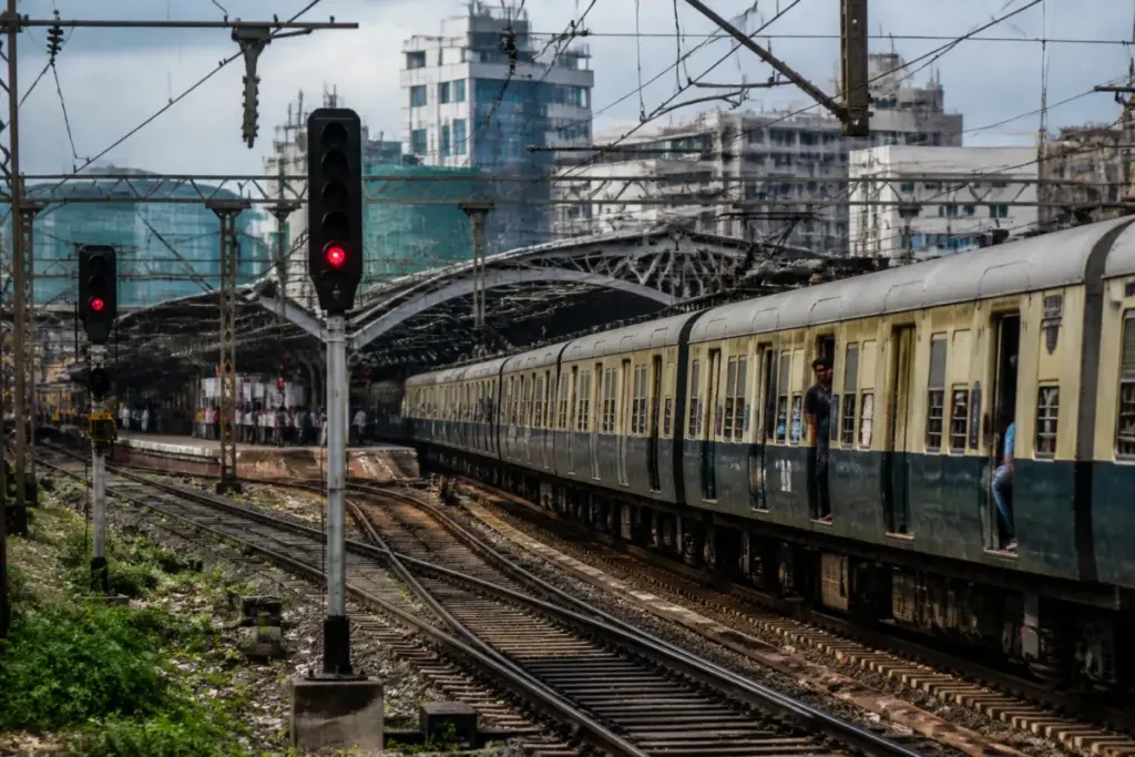 Bengaluru railway delays with a passenger train waiting outside a crowded station platform