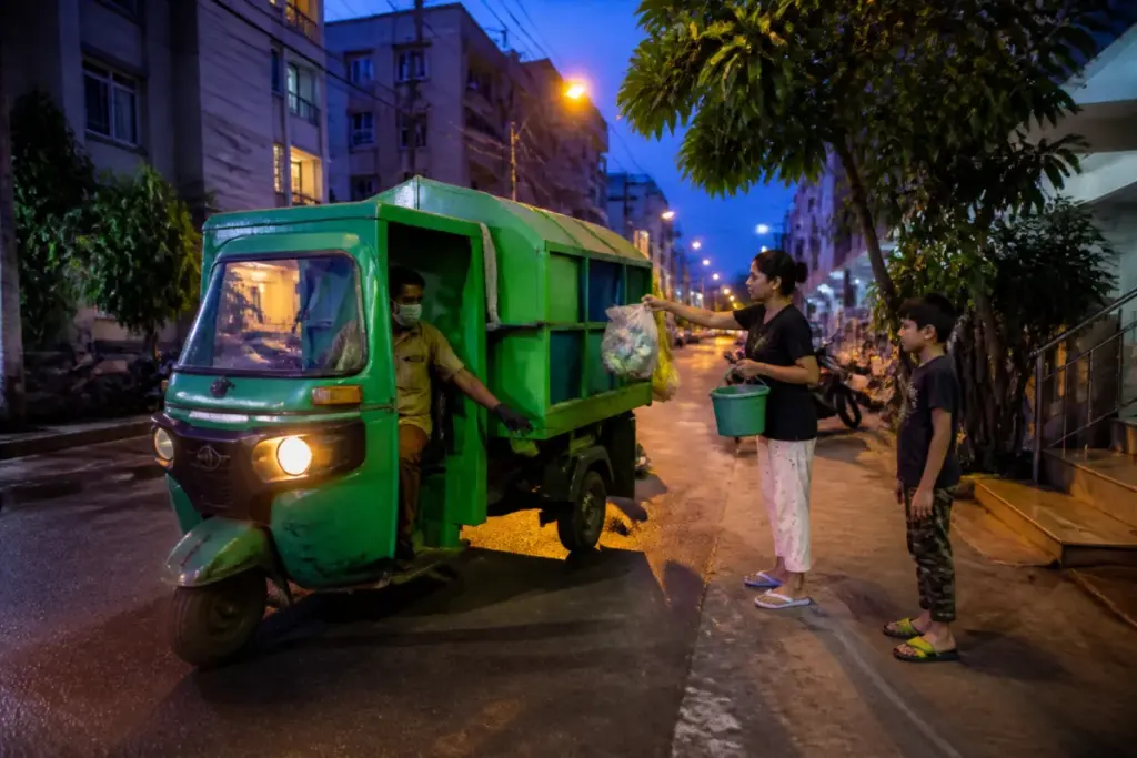 Bengaluru evening waste collection vehicle operating on a South Bengaluru street