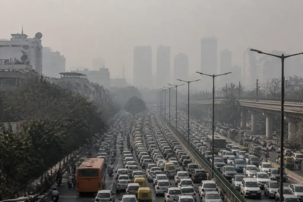 Delhi AQI pollution over a traffic-heavy road with a hazy skyline
