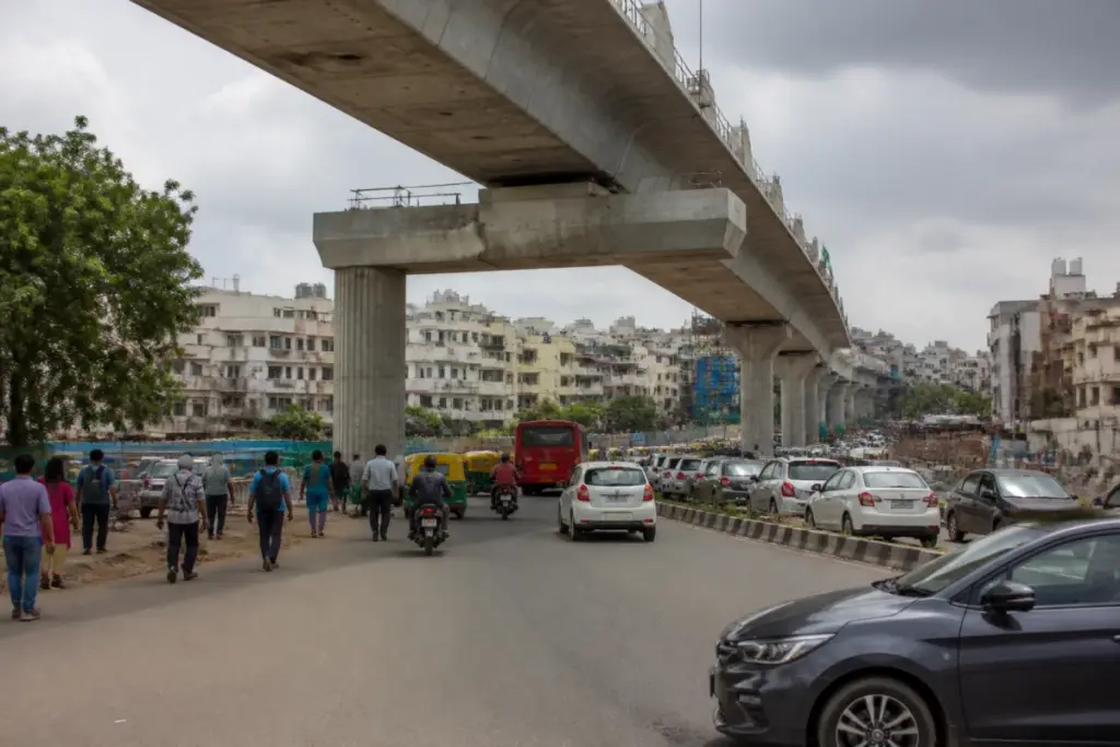 Bengaluru flyover projects on a busy urban road with elevated infrastructure and traffic below