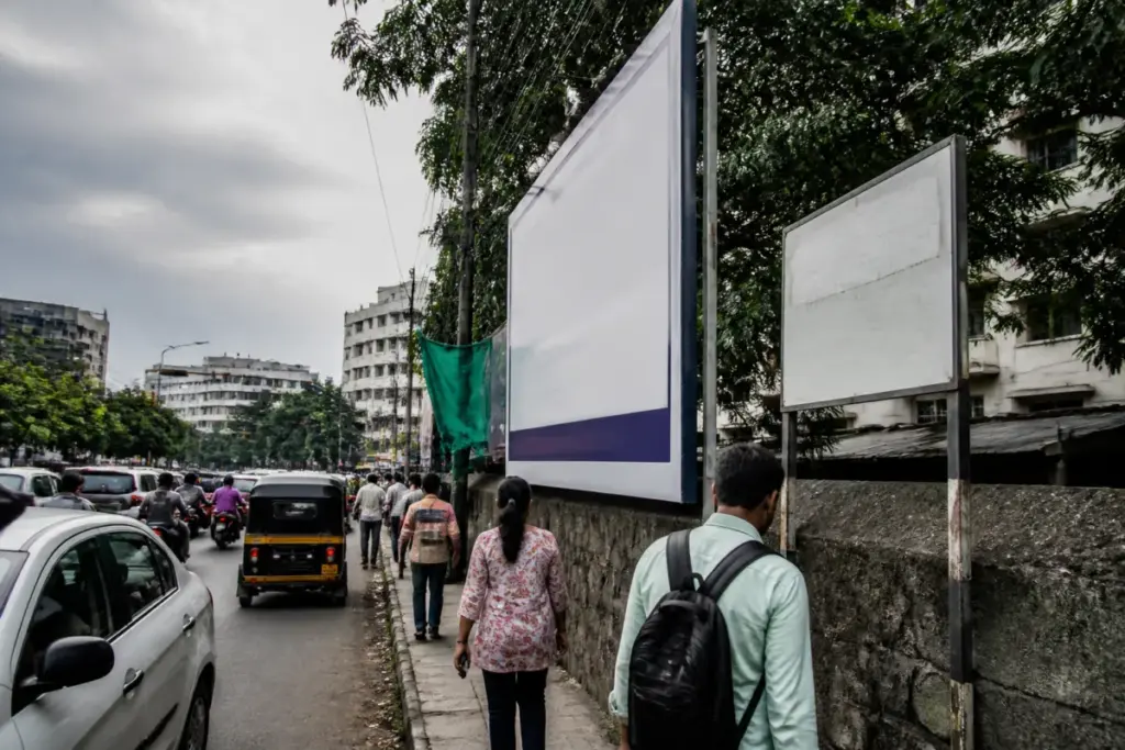 Illegal flex boards obstructing a Pune footpath near Sinhagad Road