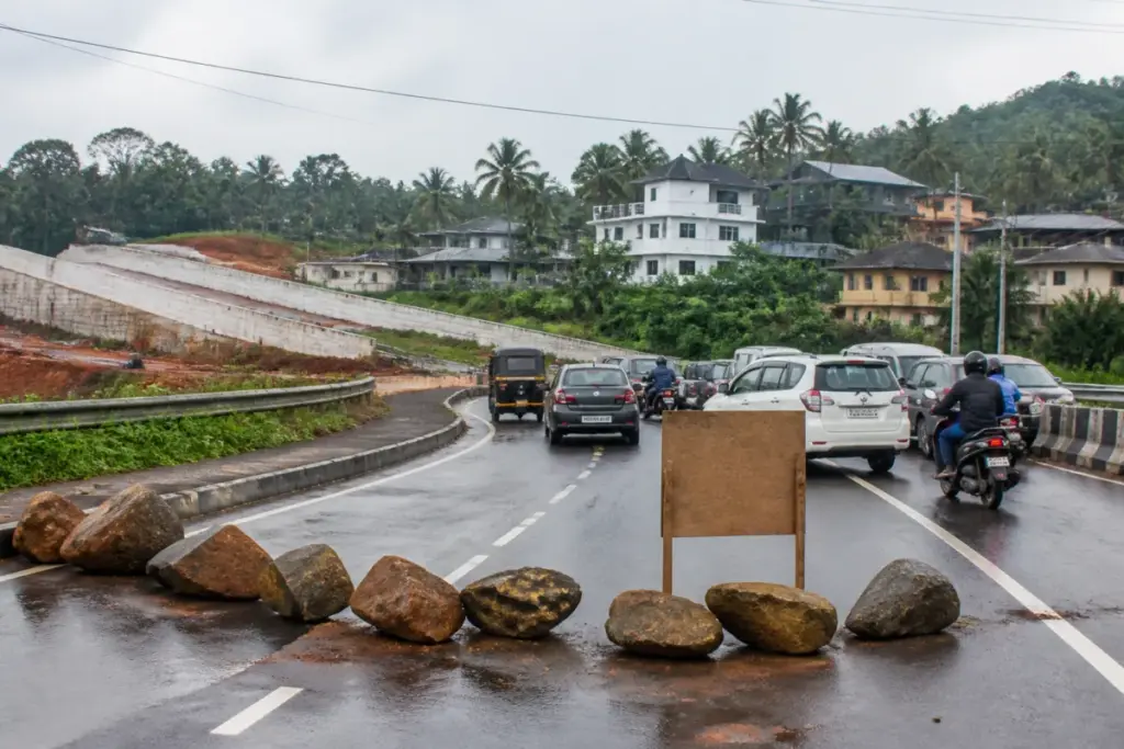 Kothamangalam bypass road blocked by stones amid a land acquisition dispute